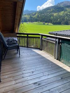 a porch with a chair and a view of a field at Techendorf 101 in Weissensee