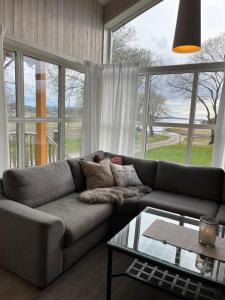 a living room with a couch and a glass table at Storeval feriehus Nærøysund in Kolvereid