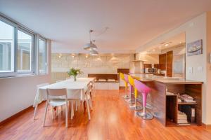 a kitchen and dining room with a table and chairs at Spacious, quiet flat in the heart of Bordeaux in Bordeaux