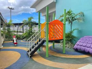 a playground in a house with a slide at Sophie's Staycation 1 BR condo in Bacolod