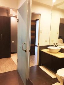 une salle de bain avec un lavabo et des toilettes dans l'établissement UpperHouse Hotel Formerly Pacifico Boutique by Hiverooms, à Cagayán de Oro
