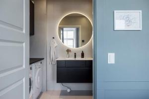 a bathroom with a sink and a mirror at Luxurious Inner-City Flat in Malmö +30 photos