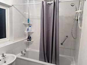 a bathroom with a shower curtain and a sink at The Peace Place in Darlington