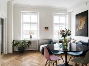 a living room with a table and chairs at Luxurious Inner-City Flat in Malmö