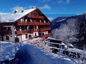 a large wooden building in the snow at Studio Cabine Saint-Gervais in Saint-Gervais-les-Bains