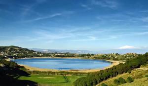 a large lake in the middle of a field at Casa tua a Pergusa in Pergusa