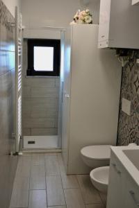 a bathroom with a shower and a toilet in it at Casa tua a Pergusa in Pergusa +21 photos