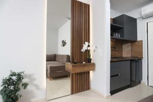a living room with a couch and a table with flowers at Danae Comfort Living in Pefkochori