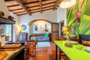 a living room with a green table and a couch at Casa Rosa a Murlo in Murlo