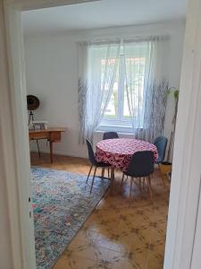 a dining room with a table and chairs and a window at Serenissima Retro Apartment in Muggia