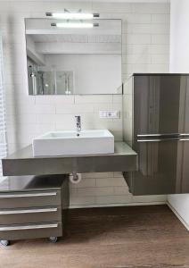 a bathroom with a sink and a mirror at Alpin Lake Haven in Molveno