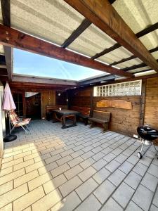 a patio with a ping pong table and chairs at Charmante Ferienwohnung Ziegler mit Garten in Villmar