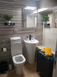 a bathroom with a white toilet and a sink at Room No stress on Cres in Cres