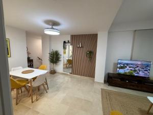 a living room with a tv and a table and chairs at El cachorro de Triana in Seville