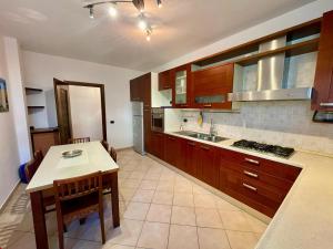 a kitchen with wooden cabinets and a table and a counter at Il Borgo Alpino in Domodossola