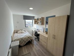 a bedroom with a bed and a desk in it at For Student Only Trinity Square in Nottingham in Nottingham