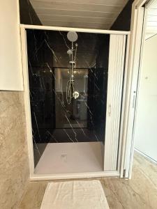 a glass door in a room with a shower at La Perla di Dea in Lido Di Fondi +42 photos
