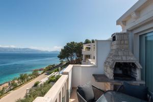 a view of the ocean from the balcony of a house at APARTMENTS BRUNO 1&2 - two-room penthouse apartments - wonderful panoramic view of the sea - the best location, first row to the beach - 10 minutes from Supetar ferry port - free secured parking - facilities nearby in Sutivan