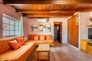 a living room with a couch and a table at Casa 2 Hermanas Formentera in Illes Balears +13 photos