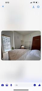a bedroom with a large bed and a window at Sophie's Staycation 1 BR condo in Bacolod +11 photos