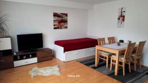 a living room with a table and a dog laying on the floor at Haus Broni in Prem +3 photos