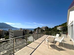 a balcony with chairs and a view of the water at Apartments Marina in Bečići