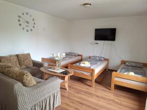 a living room with a couch and a tv at Aki in Drvar