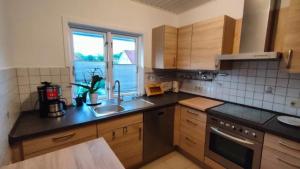 a kitchen with a sink and a window at Ferienwohnung Duderstadt in Duderstadt