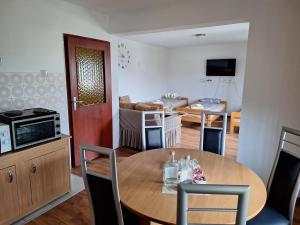 a kitchen and dining room with a table and a dining room at Aki in Drvar