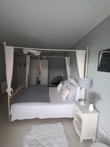 a bedroom with a large bed with white pillows at Rincón del Mar Terrazas y vistas a la Ría de Vigo in Moaña +87 photos