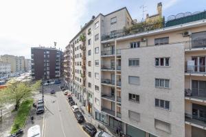 an apartment building in a city with a street at Via Santa Croce 1 in Milan