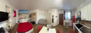a living room with a red bed in a room at J&M House in Fondi