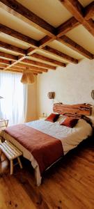 a bedroom with a large bed in a room with wooden ceilings at AMEIO - Country House in Rio Maior +40 photos