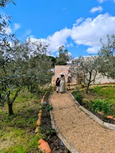 two people walking down a path in a garden at AMEIO - Country House in Rio Maior