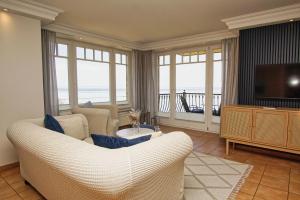 a living room with a couch and a television at Ferienwohnung mit traumhaftem Meerblick - Haus am Meer FeWo 05 in Lohme