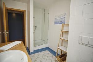 a bathroom with a sink and a shower at Ferienwohnung mit traumhaftem Meerblick - Haus am Meer FeWo 05 in Lohme +27 photos