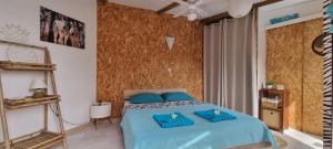 Postel nebo postele na pokoji v ubytování Zananas Bungalow privé chez l'habitant