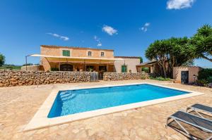 a swimming pool in front of a house at YourHouse Agroturismo Can Porreti El Galliner in Lloret de Vistalegre