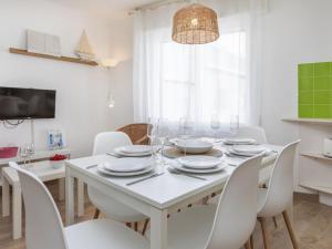 a white dining room with a white table and chairs at Apartment Marinada by Interhome in Tossa de Mar +16 photos