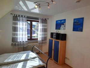 a bedroom with a bed and a window at Ferienwohnung Rosenthal in Bad Marienberg