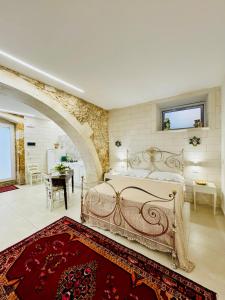 a bedroom with a bed and a table in a room at Riviera del Mare House in Siracusa