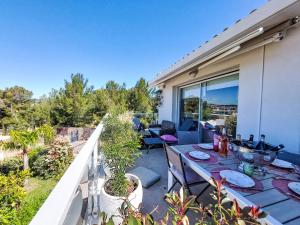 taras ze stołem i krzesłami na balkonie w obiekcie Apartment Les Terrasses d'Azur-1 by Interhome w mieście Sanary-sur-Mer