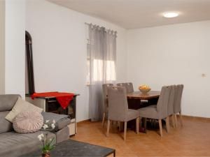 a living room with a couch and a dining room table at Holiday Home Angels Retreat by Interhome in Maslenica