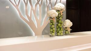 a vase filled with flowers sitting on a counter top at Stanford Hillview Hotel Hong Kong in Hong Kong