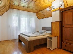 a bedroom with a bed and a window at Holiday Home Green House by Interhome in Balatonmáriafürdő
