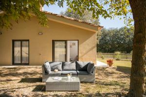 a couch sitting in a yard in front of a house at La Caseta in Sant Jaume de Llierca