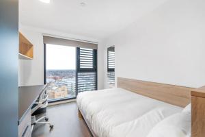 a bedroom with a bed and a large window at Canvas Arundel House in Coventry in Coventry