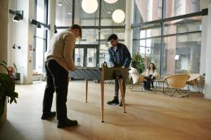 two men playing a game on a table in an office at Canvas Arundel House in Coventry in Coventry