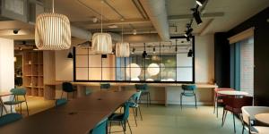 a dining room with a long table and chairs at Canvas Arundel House in Coventry in Coventry