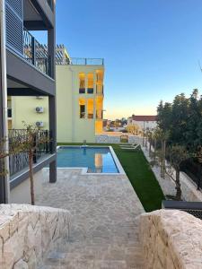 a house with a swimming pool next to a building at Exclusive Resort Vista Hills Apartman Blue Horizon in Sevid